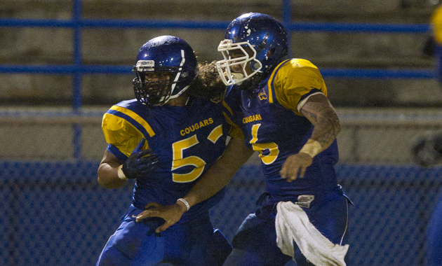 Kaiser line backer Fitou Fisiiahi was congratulated by teammate Tommy Fisher after running the ball in for a touchdown in the last minute of the second quarter against Campbell on Friday. (CIndy Ellen Russell / Star-Advertiser)