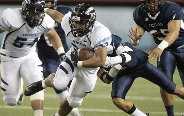 Kamehameha's Brandon Kahookele blew past Saint Louis' Micah Todd during the first half of Friday's game at Aloha Stadium. (Jamm Aquino / Star-Advertiser)