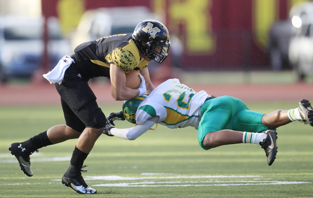 McKinley quarterback Denzel Kalahiki-Gasper got past Kaimuki's Sean Noda on Saturday night at Roosevelt High. (Krystle Marcellus / Star-Advertiser) 