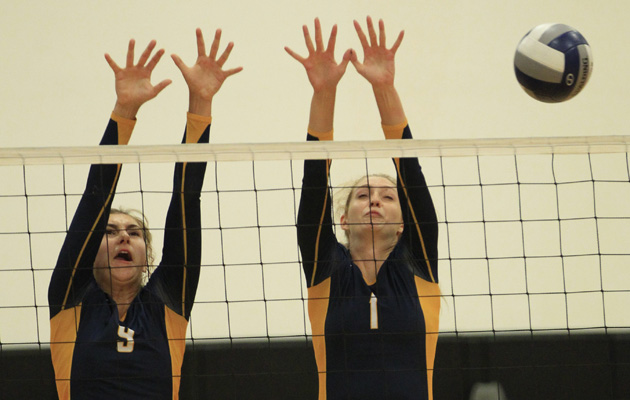 Punahou's Kelly Matthews and Marissa Behrens blocked a kill attempt against Huntington Beach at the 2013 Ann Kang volleyball tournament. (Krystle Marcellus / Star-Advertiser)