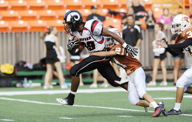 Radford receiver Absolom Henry picked up yards after catching a pass from quarterback Cody Lui-Yuen as Pac-Five's Casey Nakamura tried to bring him down in the second quarter on Aug. 10, 2013, at Aloha Stadium. (Bruce Asato / Star-Advertiser)