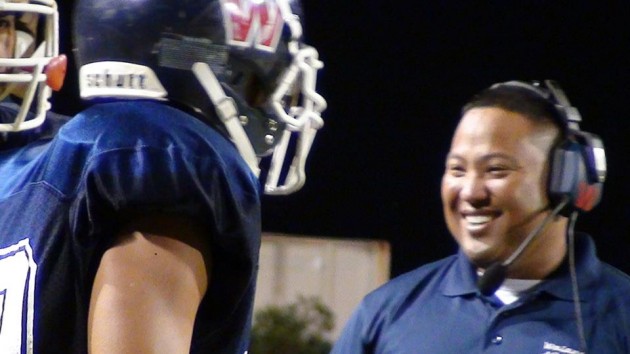 A Waianae assistant coach is pleased with his linemen. (Paul Honda / Star-Advertiser)