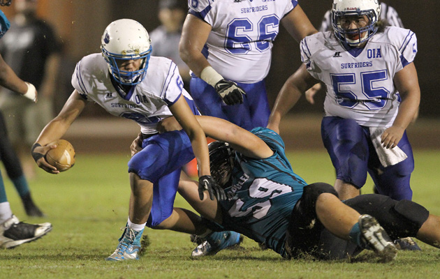 Kapolei's Masi Tunoa brought down Kailua QB Noah Auld in the second quarter on Friday. Auld and the Surfriders came back and finished strong. (Jay Metzger / Special to the Star-Advertiser)