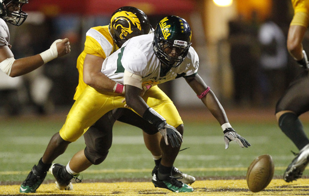 Leilehua's Randy Neverson fumbled after getting hit by a Mililani defender on Saturday night.. (Krystle Marcellus / Star-Advertiser)