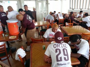 The Governors enjoy the hospitality — a hearty pre-game meal — of Farrington alums now residing on Maui. (Photo courtesy of Petro Kesi)