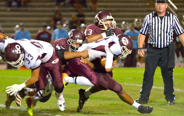 Farrington's Sanele Lavatai tried to run through Baldwin’s Teva Elridge (43) and Brandon Silva. (Rodney S. Yap / Special to the Star-Advertiser)