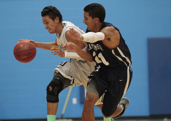 St. Francis' Matthew Nuumanaia dribbled past Kamehameha's Fatu Sua-Godinet during the second half of the 2013 Merv Lopes Classic semifinal basketball game on Saturday, Dec. 28, 2013 at St. Francis High School. (Jamm Aquino / Star-Advertiser)