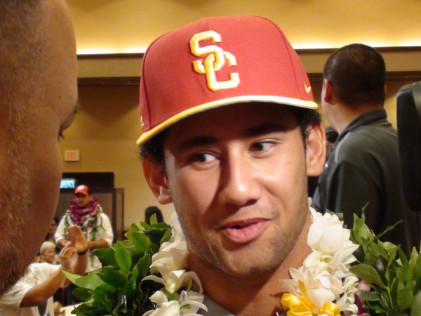 Punahou's Larry Tuileta kept hats off his head until after signing his letter. (Paul Honda / Star-Advertiser)