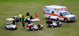 Emergency personnel treat Mid-Pacific's Kohei Tomita.