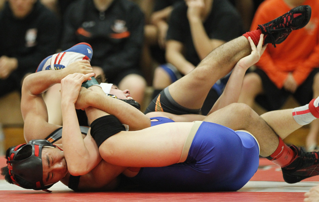 Mid-Pacific's Joshua Terao, left, wrestled Punahou's Joshua Crimmins in the boys 132-pound championship bout of the 2014 ILH wrestling championships on Saturday, Feb. 22, 2014 at 'Iolani School. (Jamm Aquino / Star-Advertiser)