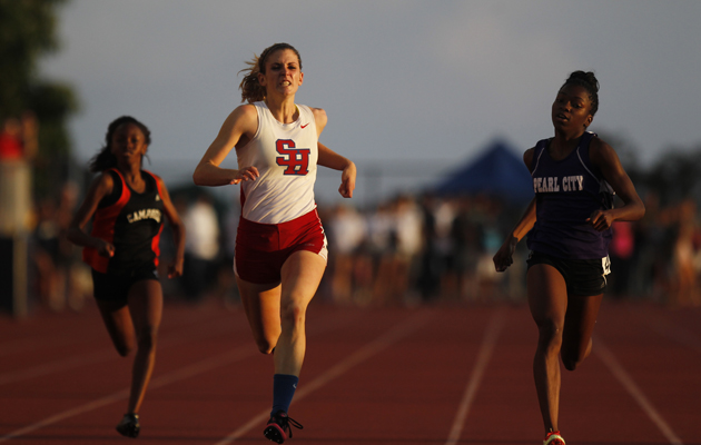 Seabury Hall's Alyssa Bettendorf, middle, took first in the girls 200-meter dash.