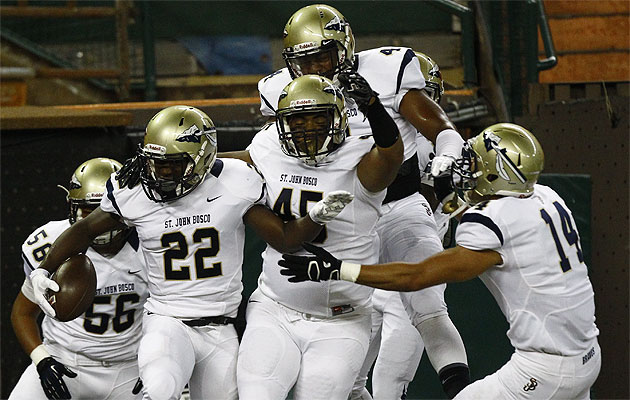 St. John Bosco's Clifford Simms (22) celebrates with Joseph Taliauli (45) after Simms' fumble recovery for a touchdown on Friday. Honolulu Star-Advertiser/Jamm Aquino