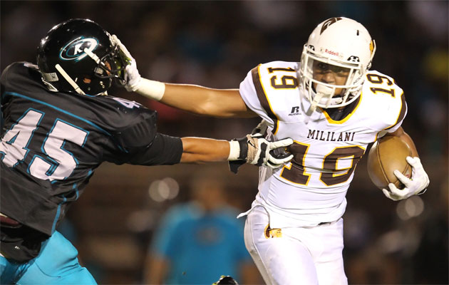 Mililani running back Vavae Malepeai fights off the Kapolei defender Lorenzen Panapa on Saturday. Photo by Darryl Oumi.