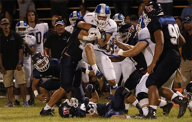 Waianae's Justice Jardine, left, tackled Moanalua's Michael Feliciano during Na Menehunes' win on Friday. Honolulu Star-Advertiser photo by Krystle Marcellus