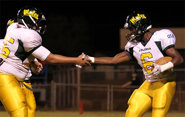 Leilehua running back Randy Neverson was congratulated by teammate Bronson Moala after scoring a touchdown on Friday. Photo by Darryl Oumi. 