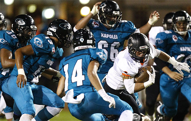 Campbell's Austin May was swarmed by the Kapolei defense in a game in 2014.  New rules will make it even harder for defenders to make clean hits on opposing players. Photo by Jamm Aquino/Honolulu Star-Advertiser.