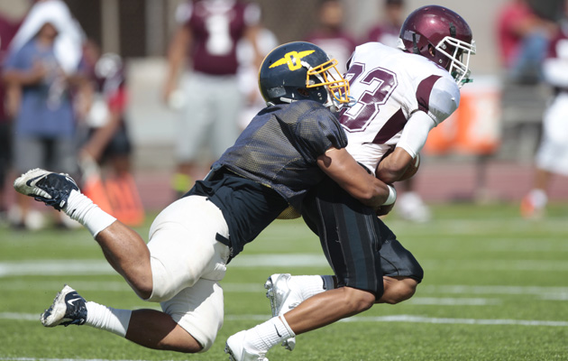 Punahou's Ronley Lakalaka stops a Farrington player during a pre-season scrimmage between the Farrington Governors and the Punahou Buffanblu on Saturday, August 2, 2014 at Punahou School in Manoa.  (Honolulu Star-Advertiser/Jamm Aquino).