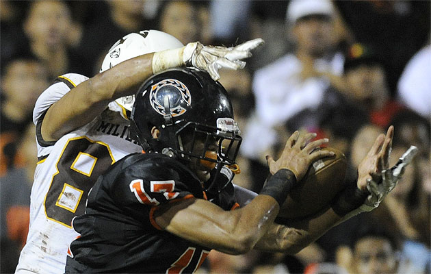 Campbell's Dylan Villanueva intercepts a Mililani pass in the end zone in front of Mililani's Kalakaua Timoteo earlier this year. Bruce Asato / Star-Advertiser