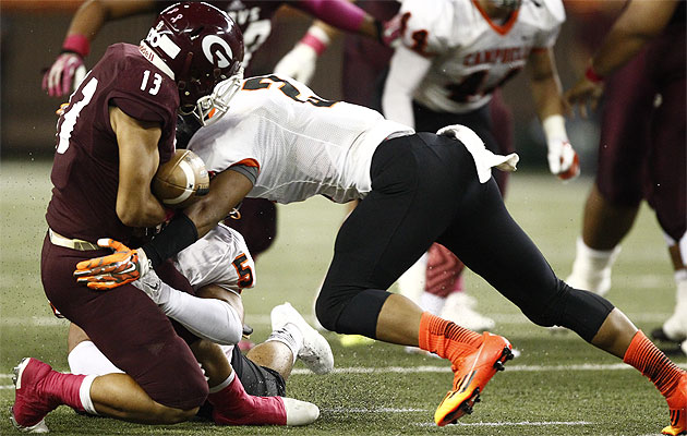 Campbell's Abiel Taito forced Farrington's Challen Faamatau to fumble the ball. Jamm Aquino / Star-Advertiser