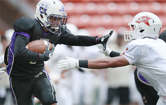 The Damien vs. Pac-Five rivalry continues in the fall, with two games scheduled for Aloha Stadium. Dutch Claybaugh threw a stiffarm at Pac-Five's Trevor Yee in a game from Oct. 14, 2014. George F. Lee / Honolulu Star-Advertiser