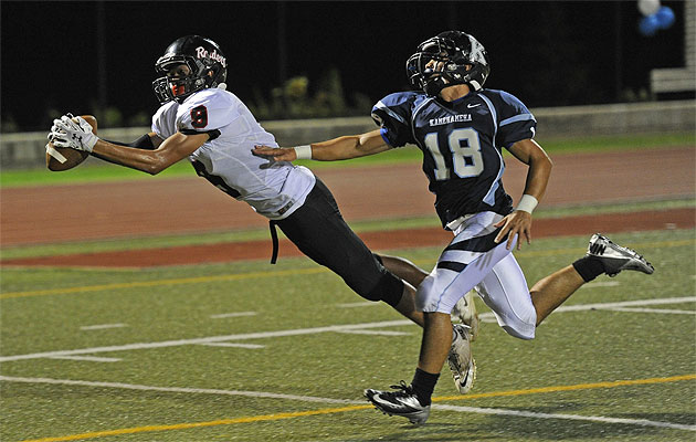 Iolani's Connor Ohira beat Kamehameha's Chad Farias to the ball for a touchdown late in the second quarter on Friday. Bruce Asato / Star-Advertiser