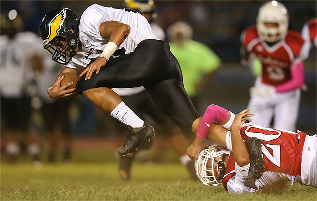 Nanakuli linebacker Alexcio Meyers was tackled by Kalani defensive back Landon Yoshinaga on Saturday. Darryl Oumi / Special to the Star-Advertiser.