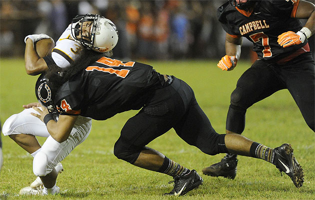 Campbell's Solomon Matautia laid a hit on Mililani's Joshua Butac earlier this year. Bruce Asato / Star-Advertiser