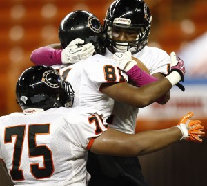 Campbell's Jayce Bantolina, top, was embraced by teammates Alika Bantolina, middle, and Arona Amosa after scoring a touchdown on Saturday. Jamm Aquino/Star-Advertiser.