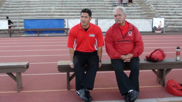 Lahainaluna co-head coaches Garrett Tihada and Bobby Watson take a moment to talk during pre-game warmups. Lahainaluna defeated Kamehameha-Hawaii 52-7 on Saturday at War Memorial Stadium. 