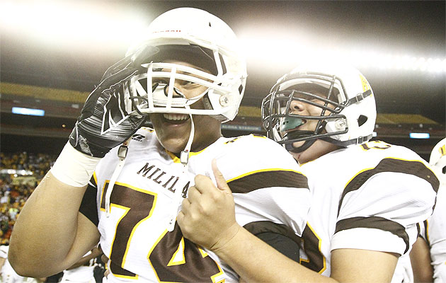 Mililani's Marcus Mafi, left, reacts with team mate Kingston Maae as time runs out on Friday. Jamm Aquino / Star-Advertiser