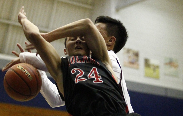 ‘Iolani's John Lee is fouled by Farrington's Montana Liana during the first half of a pre-season boys high school basketball game between the Iolani Raiders and the Farrington Governors on Thursday, December 11, 2014 at Moanalua High School in Honolulu.   (Honolulu Star-Advertiser/Jamm Aquino).