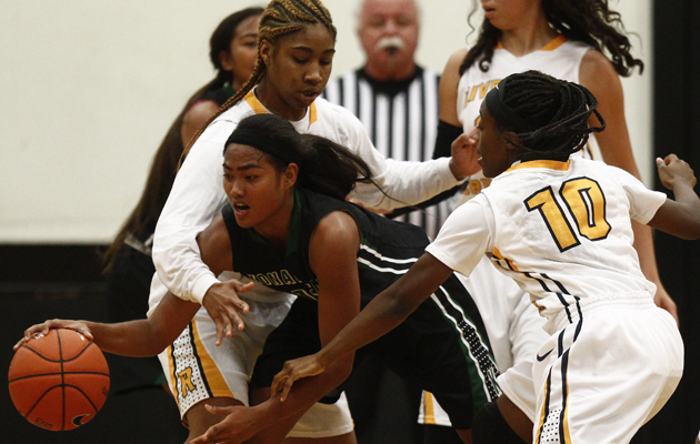 Konawaena's Chanelle Molina cuts between Riverdale Baptist's Kierra Turner, left, and Chanel Belton during the first half of a girls high school basketball game between the Riverdale Baptist Crusaders (Md.) and the Konawaena Wildcats on Friday, December 12, 2014 at Iolani School gymnasium in Moiliili.   (Honolulu Star-Advertiser/Jamm Aquino).