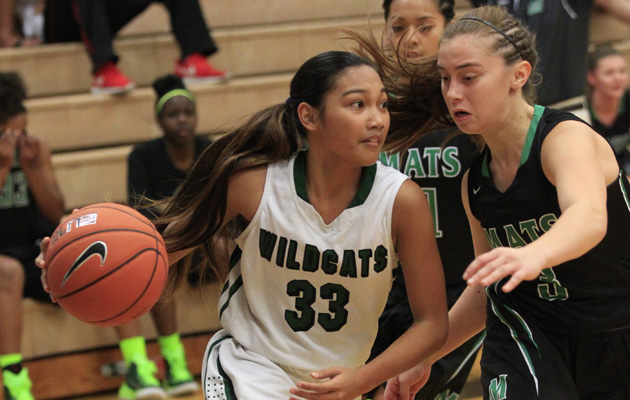 Konawaena's Cherilyn Molina drove into the key with Miramonte's Clair Steele following during the first period of the Iolani Classic held on Thursday evening. Honolulu Star-Advertiser photo by Cindy Ellen Russell.
