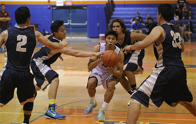 Farrington's Ranan Mamiya was surrounded by Punahou defenders on Friday. Bruce Asato / Star-Advertiser