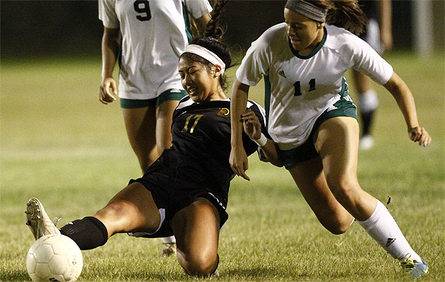  Mililani's Tia Furuta kicks the ball away from Aiea's Jordan Hill. Jamm Aquino / Star-Advertiser