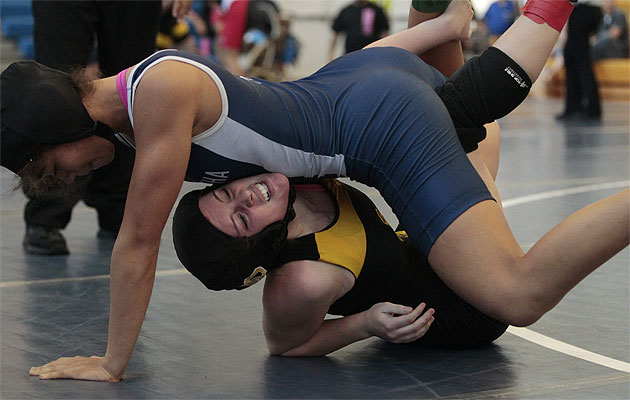 Zion-Grace Vierra, top, wrestled her way to a win against Del Oro's Marissa Thomas at the Pa'ani Challenge.  Honolulu Star-Advertiser photo by Krystle Marcellus