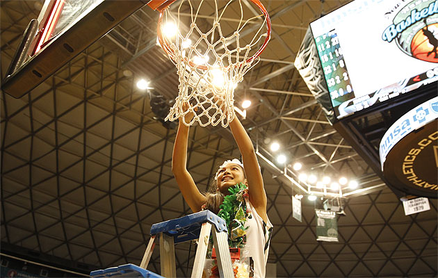 Konawaena freshman guard Cherilyn Molina cuts down the net after the Wildcats defeated Lahainaluna 51-41 in the finals of the D-I state tournament.  (Jamm Aquino/Honolulu Star-Advertiser).