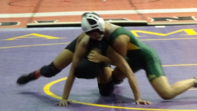 Kayla Lono (Leilehua), at right, battles Sydnie Lista (Farrington) in an opening-round match in the girls 112 weight class of the Chevron/HHSAA State Wrestling Championships on Friday, Mar. 6, 2015. Paul Honda/Star-Advertiser. 