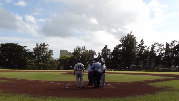 MPI coach Dunn Muramaru and Kamehameha coach Tommy Perkins meet with umpires before the first pitch. Paul Honda/Star-Advertiser