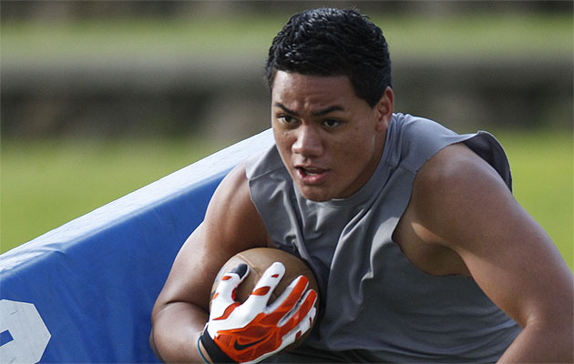 Punahou Running back Wayne Taulapapa went through some drills during spring practice on Friday. He's looking forward to the 2015 season a lot more than he is looking back to the final game of 2014. Jamm Aquino / Star-Advertiser. 