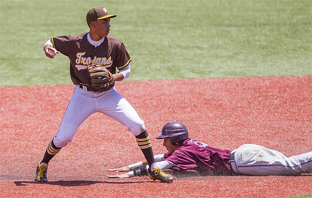 Mililani's Justice Nakagawa forced out Chayce Akaka of Baldwin in an early game. Cindy Ellen Russell / Star-Advertiser 