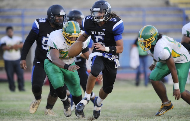 Anuenue's Kona Kelekolio rushed for two touchdowns and threw for another in 2014. Photo by Bruce Asato/Star-Advertiser.