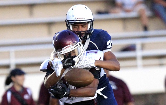 Two Kalihi-area schools will play in a preseason scrimmage Thursday as Farrington visits Kamehameha at 6 p.m. In photo, Farrington's Jathen Chaffin went up against Kamehameha's Desmond Unutoa in last year's scrimmage. Cindy Ellen Russell / Honolulu Star-Advertiser.