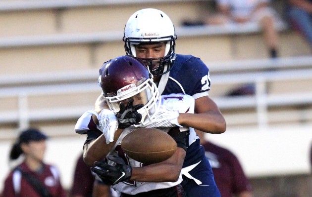 Desmond Unutoa of Kamehameha tried to bring down Farrington's Jathen Chaffin during Thursday's scrimmage. Cindy Ellen Russell / Honolulu Star-Advertiser