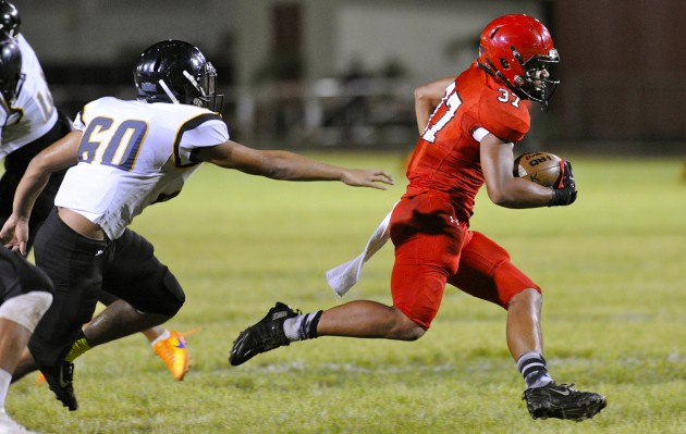 Kahuku can run. The Red Raiders' Sefa Ameperosa eluded McKinley's Dyllon Enriquez en route to one of his three touchdown runs in Friday's 78-0 victory over McKinley. But, the question is sitting there waiting to be answered eventually: Can Kahuku pass? Bruce Asato / Honolulu Star-Advertiser.