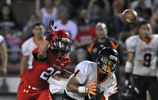 2015 August 7 SPT - Campbell v Kahuku FB - Campbell's Noah Esprecion makes a catch in front of defender Kahuku’s Stokes Botelho in the second quarter of the Campbell vs Kahuku football game at Kahuku field.  HSA photo by Bruce Asato