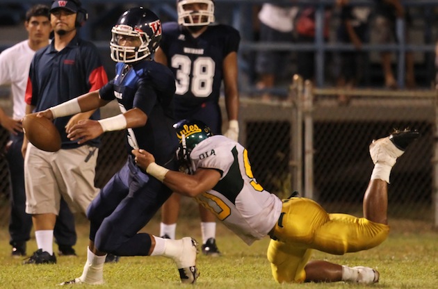 Waianae QB Ioane Kaluhiokalani Jr. was sacked by Leilehua's Soga Eli in a 2014 game. Photo by Darryl Oumi/Special to the Star-Advertiser.