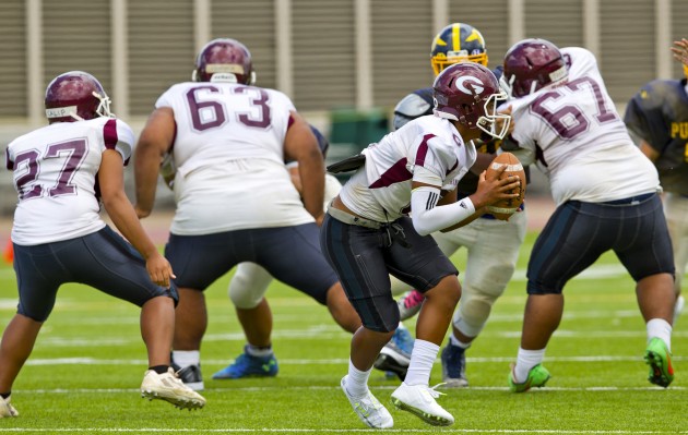 Farrington's qb Joziah Anakalea (6) gets protection from his massive offensive line as he drops back to pass.  PHOTO BY DENNIS ODA.  AUG. 1, 2015