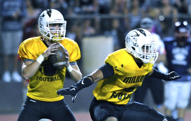 Mililani'd Mckenzie Milton looks for a receiver with running back Vavae Malepeai protecting his quarterback in the first quarter of a scrimmage with Saint Louis. HSA photo by Bruce Asato