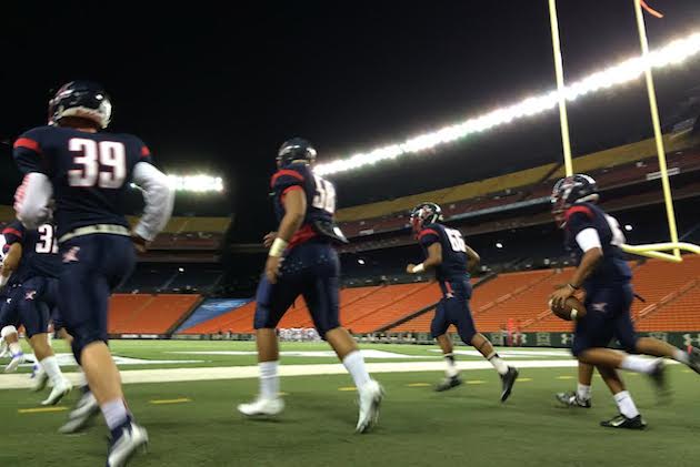 Saint Louis takes the field to play Liberty High on Saturday night at Aloha Stadium. Jamm Aquino/Star-Advertiser.